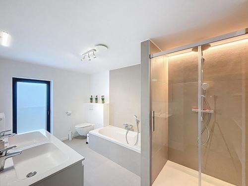 a bathroom with a shower and a sink and a toilet at Villa Pomone - Sint-Idesbald in Koksijde