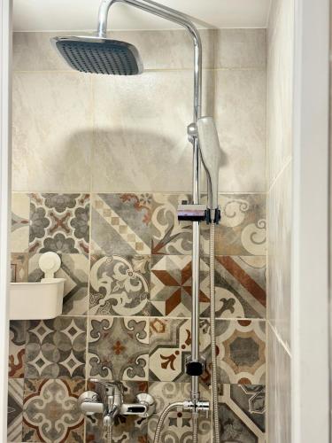 a shower in a bathroom with a tile floor at Casa Flory in Verbania