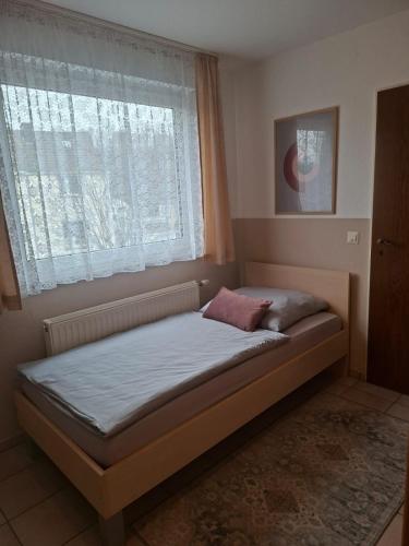 a small bed in a room with a window at Restaurant Zur Linde in Bergheim