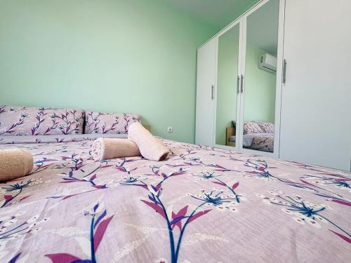 a bedroom with a large bed with a purple comforter at Modern Nest Varna - free parking in Varna City
