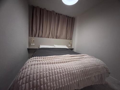 a bedroom with a large bed with a window at Araya Apartments in Benidorm