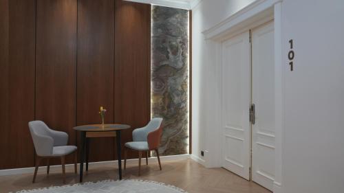 a room with a table and chairs and a door at Symphony Boutique in Tashkent