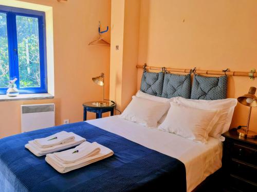 a bedroom with a bed with two towels on it at Out of Town in Castelo de Paiva