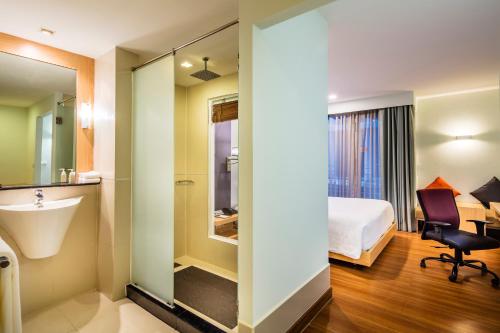 a hotel room with a bed and a sink at Hotel Solo, Sukhumvit 2, Bangkok - SHA Extra Plus in Bangkok