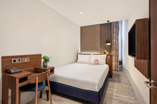 a hotel room with a bed and a desk at 91 Aparthotel Jesmond Road in Newcastle upon Tyne