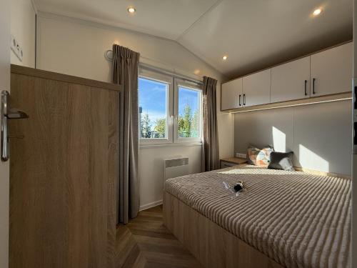 a bedroom with a large bed and a window at Bear Camp Kamionna in Kamionna