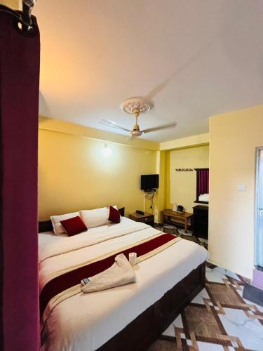 a hotel room with two beds and a ceiling at Hotel Lake shadow inn in Pokhara
