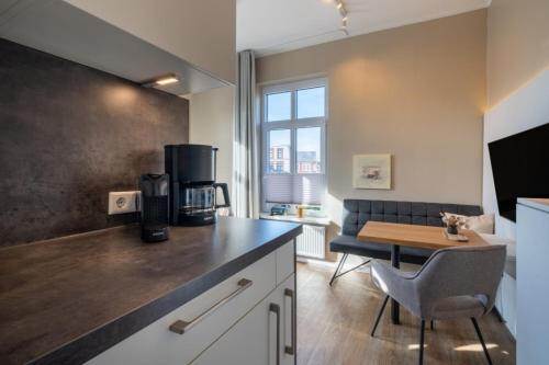 a kitchen with a counter top and a table in a room at Woge2 Appartement 7 in Borkum