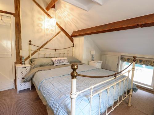 a bedroom with a canopy bed in a room at Millers Loft in Llanrwst
