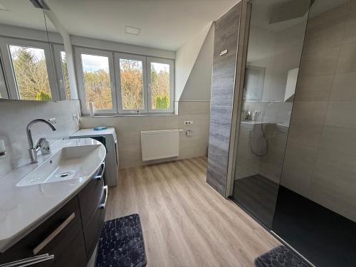a large bathroom with a shower and a sink at Ferienhaus Hirschi in Eisenach