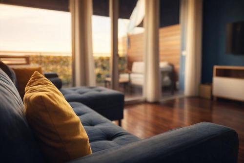 a living room with a couch with a yellow pillow at Easy Loft Milano in Crescenzago