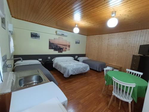 a room with two beds and a sink in it at Habitación independiente en Casa Rural Javier in Valmuel