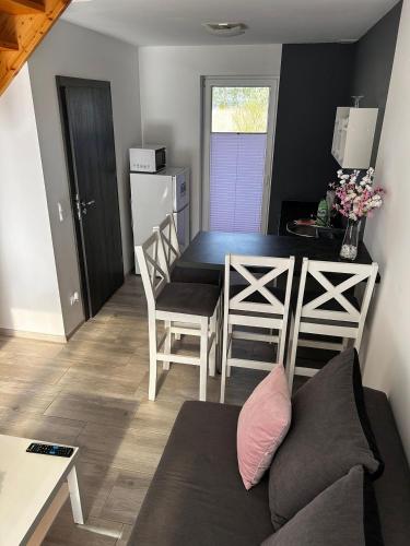 a kitchen and dining room with a table and chairs at Villa Over Lake in Mielno
