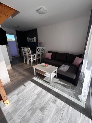 a living room with a couch and a table at Villa Over Lake in Mielno
