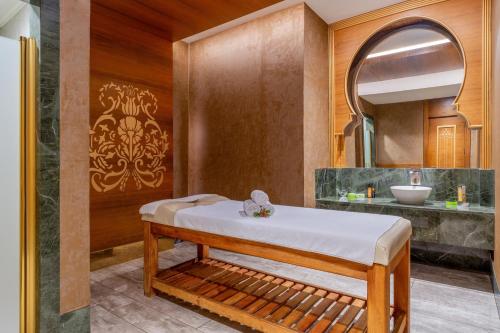 a bathroom with a bed and a sink at Haydarpasha Palace Hotel in Avsallar