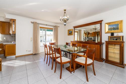 a kitchen with a dining room table and chairs at Family Beach House in Amorosa, Northern Portugal in Amorosa