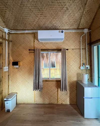 a room with a window and a air conditioner at Baan Bamboo Koh Tao in Ko Tao