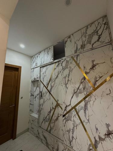 a marble wall in a room with at Hacienda napoles in Chandigarh Airport
