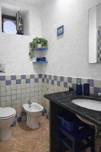 a bathroom with a toilet and a sink at Casa Marietta in Lipari