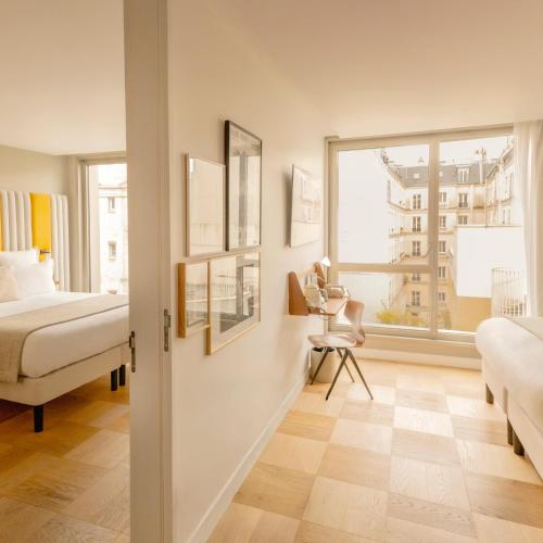une chambre avec un lit et une fenêtre dans l'établissement Hôtel Pilgrim, à Paris