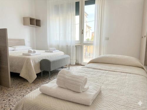 a hotel room with two beds and a window at RESIDENZE ARANCIO - Premium Villas in Giulianova