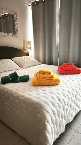 two towels are sitting on a white bed at Borinquen Vista Mar in Playa de las Americas