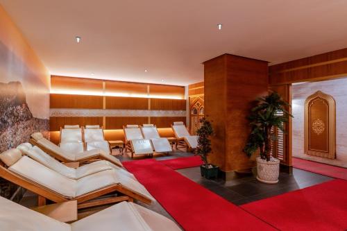 a waiting room with white chairs and a red carpet at Haydarpasha Palace Hotel in Avsallar