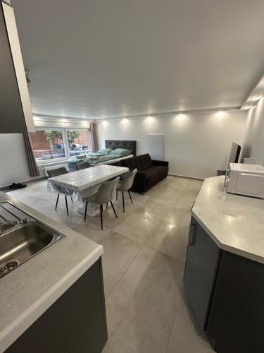 a kitchen and living room with a table and a couch at LaTerrazzaA1 in Hamm