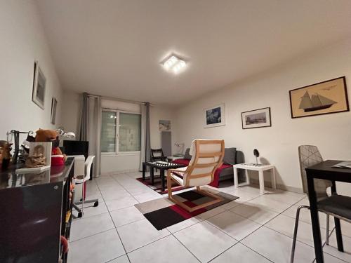 a living room with chairs and a table at 31 Bd De Launay in Nantes