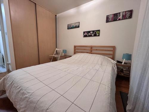 a bedroom with a large bed and three pictures on the wall at 31 Bd De Launay in Nantes