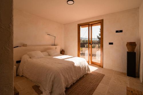 a bedroom with a bed and a large window at Casa Valentina Ronda in Ronda