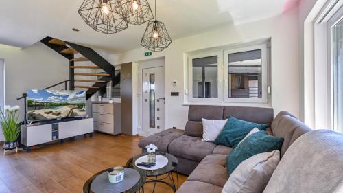a living room with a couch and a tv at Villa Lady Berga by Villas Guide in Ludbreg