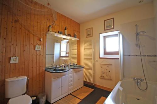 a bathroom with a toilet and a sink and a shower at Les 3 tilleuls in Bellac