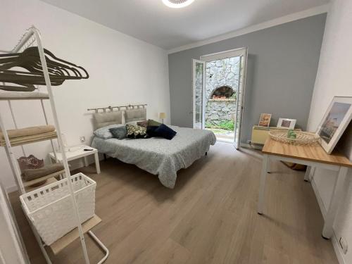 a bedroom with a bed and a ladder and a window at Casa Leone sea&terrace in Bogliasco