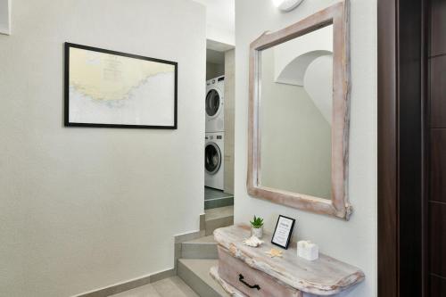 a hallway with a table and a mirror and a stairway at Studio The Waterfall - Free Parking in Balchik