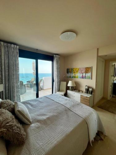 a bedroom with a bed with a view of the ocean at Best Vistamar Sea View in Torrox Costa