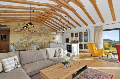 a living room with a couch and a table at Villa Sanpadeo by Rent Istria in Brtonigla