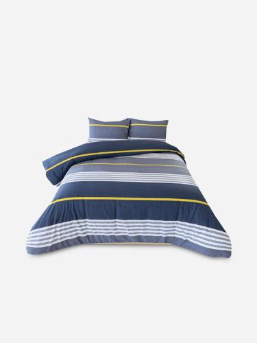 a bed with a blue and yellow striped pillow at Efkay Guest in Thohoyandou