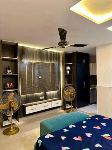 a bedroom with a ceiling fan and a large window at Nagpal Farm in Panchkula