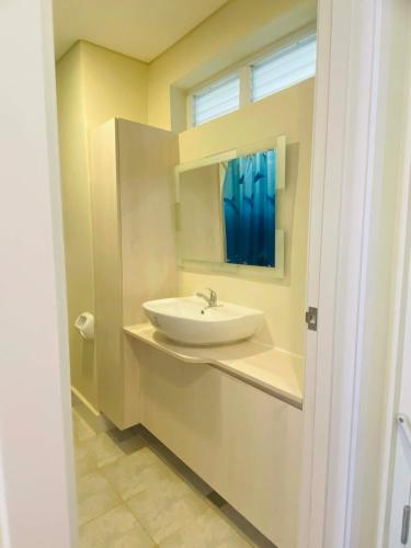 a bathroom with a sink and a mirror at Lolit cozy condo in Lapu Lapu City