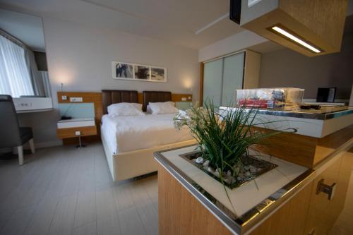 a hotel room with a bedroom with a bed and a desk at No 19 Boutique Hotel in Ankara