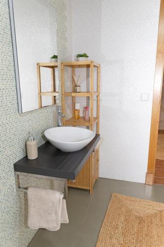 a bathroom with a large bowl sink on a counter at Casa San Son in Pontevedra