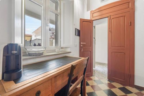 a room with a window and a wooden table at Luxar Suites & Apartments in Assemini