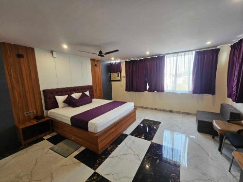 a hotel room with a bed and a couch at Hotel O D S in Rāmgarh