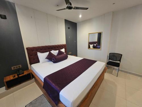 a bedroom with a large bed and a chair at Hotel O D S in Rāmgarh