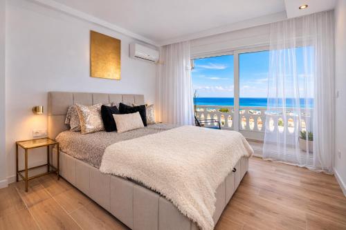 a bedroom with a large bed with a view of the ocean at Amber Signature Apartment in Torrevieja