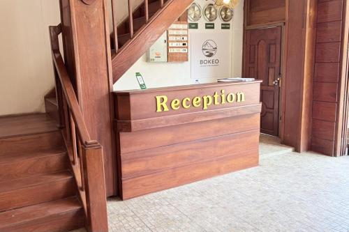 a reception desk in a room with stairs at Bokeo Lodge & Restaurant in Ban Houayxay