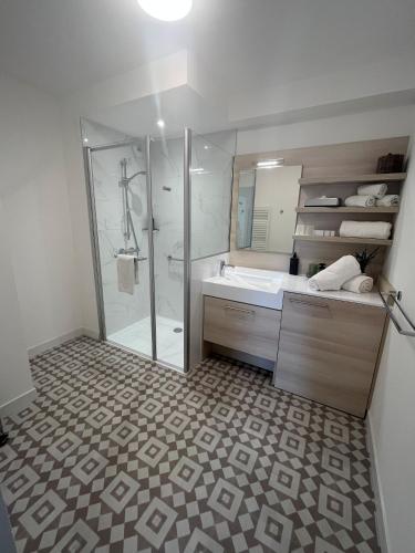 a bathroom with a shower and a sink at DOMITYS - L'Elyme des sables in Neufchâtel-Hardelot
