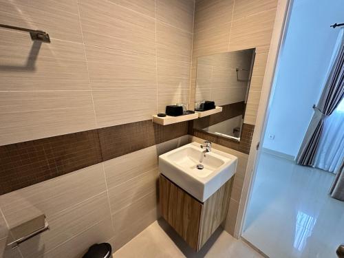 a bathroom with a sink and a mirror at Timber Sanctuary at Rancamaya in Ciawi Bogor