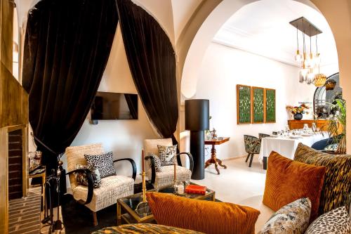 a living room with a couch and chairs and a table at Riad Anaqa in Marrakesh